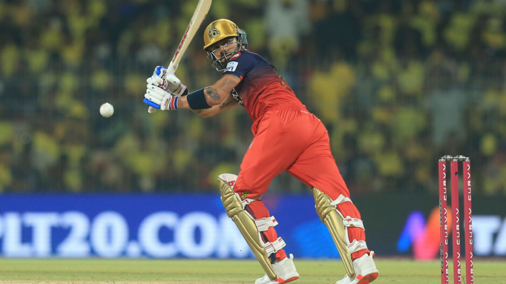 Virat Kohli's 1000 Boundaries in IPL milestone celebrated with a powerful shot during an IPL 2025 match, wearing the RCB jersey.