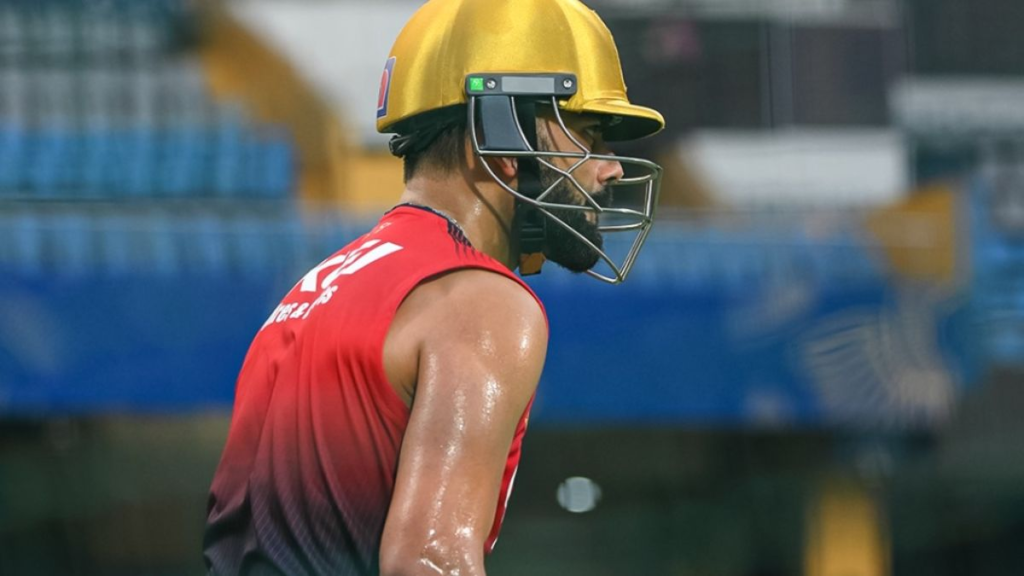2019 World Cup Semifinal Loss Reaction shown as a determined cricketer wearing a gold helmet and red training jersey walks off a cricket field drenched in sweat.